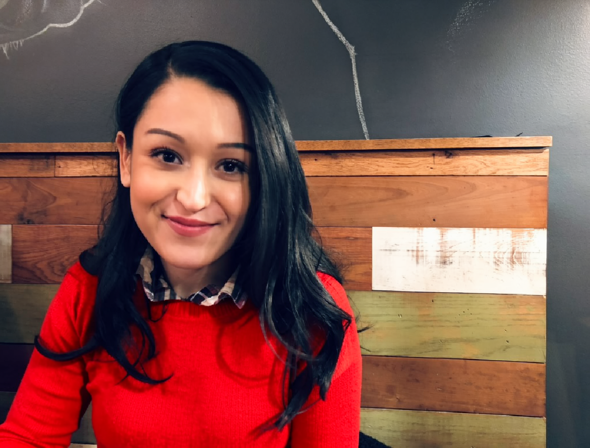 Edited image of the same woman wearing a red sweater
